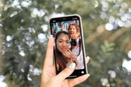 woman holding black android smartphone